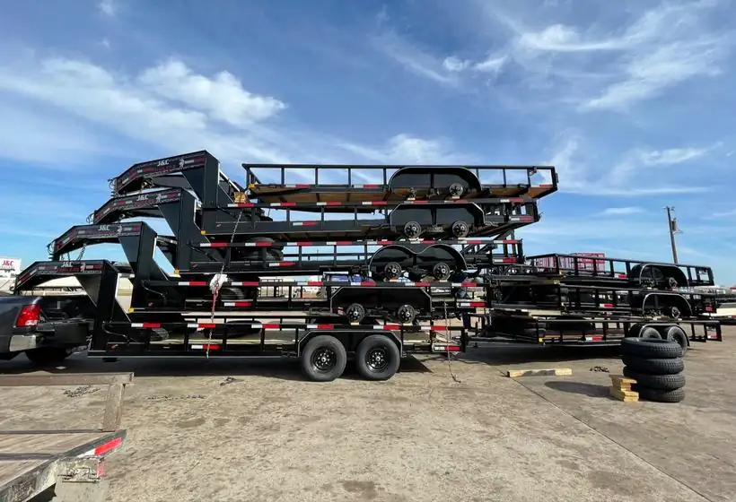 J&C equipment trailer with dump trailers lined up behind it