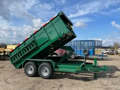 Green dump trailer with the bed raised