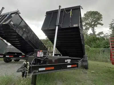 Two dump trailers with the beds raised