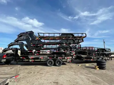 Gooseneck trailers stacked for a dealer delivery