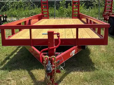 Red equipment trailer with stand-up ramps
