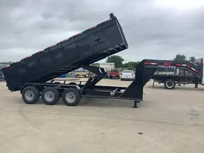 Triple-axle gooseneck dump at full lift