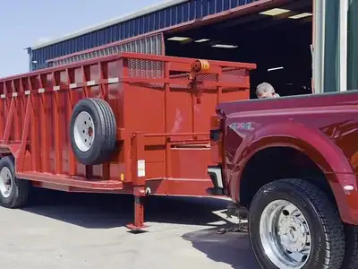 Red triple-axle gooseneck dump