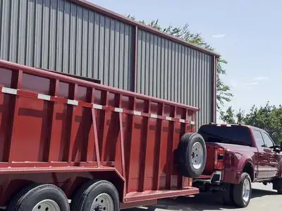 Triple axles under a red gooseneck dump