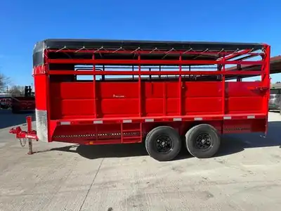 Red livestock trailer with tarp top