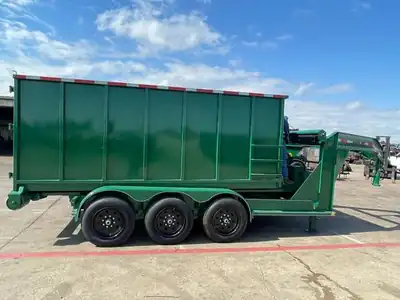 Green triple-axle gooseneck roll-off