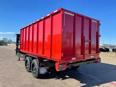 Red roll-off container loaded on the trailer